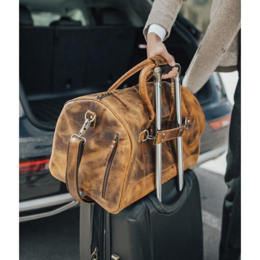 the denali leather duffel bag for men on suitcase